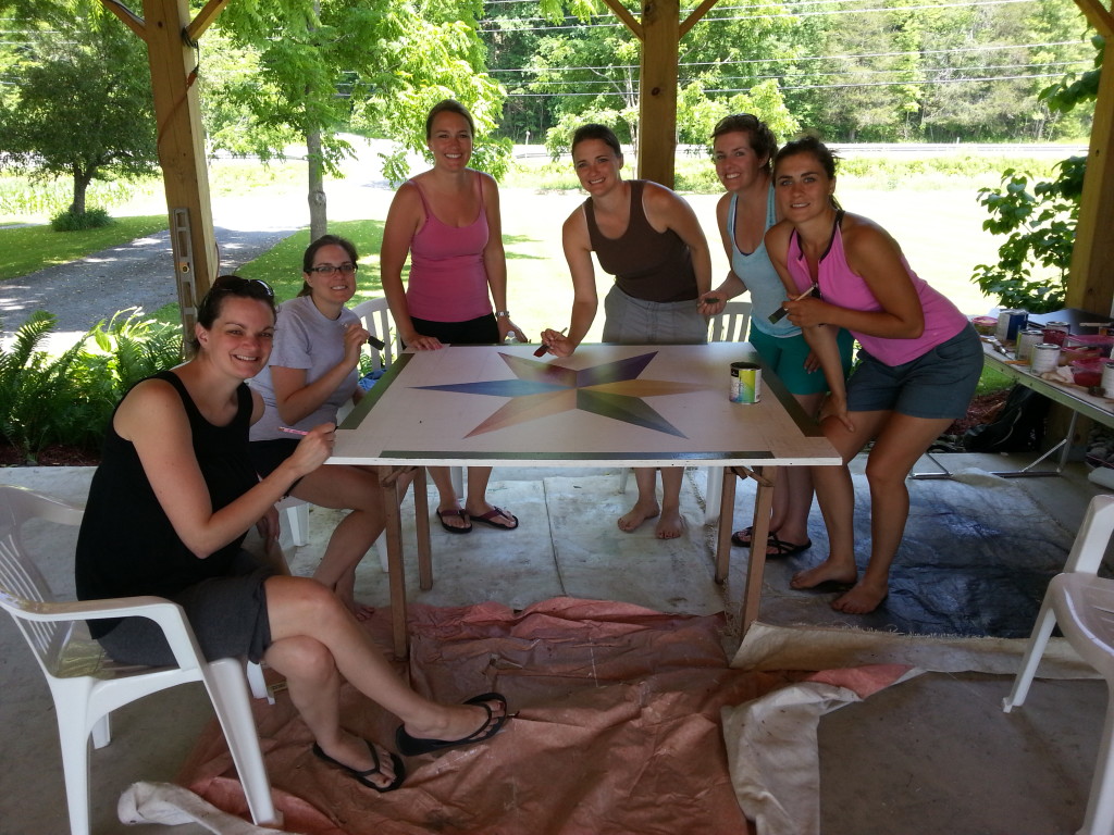 Members of the 6th generation of Barbers work on the quilt block. 